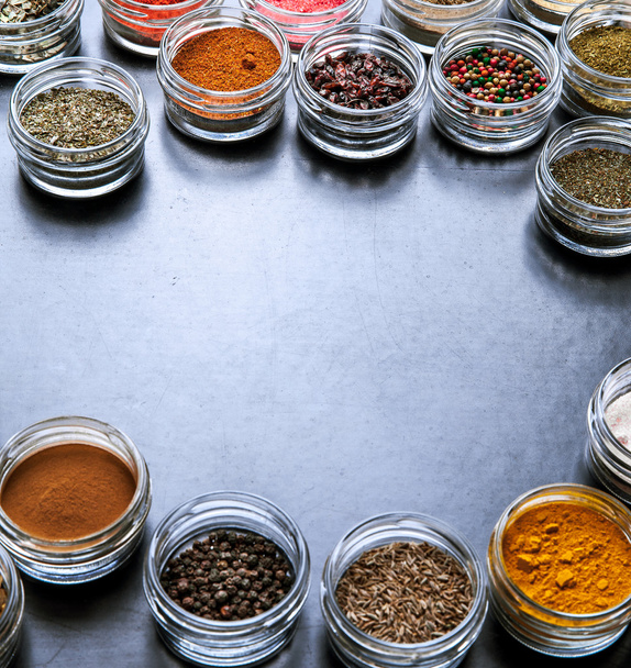 Spices on black background in special jars. Food - Zdjęcie, obraz