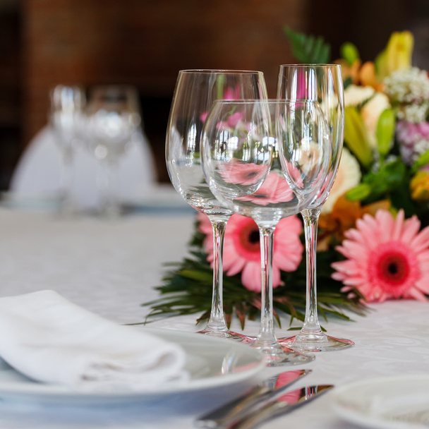 serving of the holiday table, three glasses, plates, cutlery and - 写真・画像