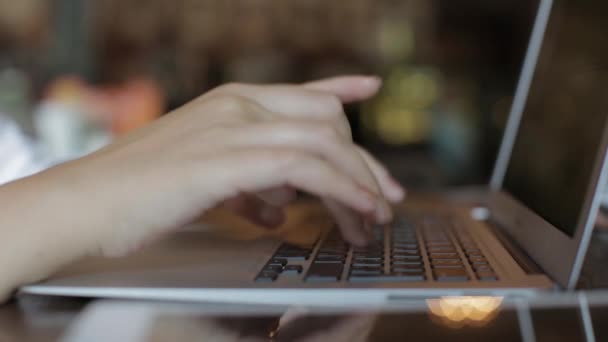 girl working on laptop sitting in a cafe. closeup - Кадри, відео