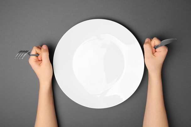 Female hands with cutlery and empty plate - Foto, Imagem