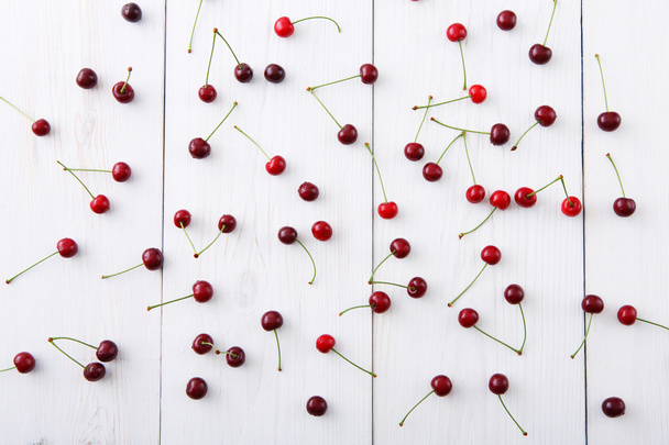 Sweet fresh cherries on white wood background - Photo, image