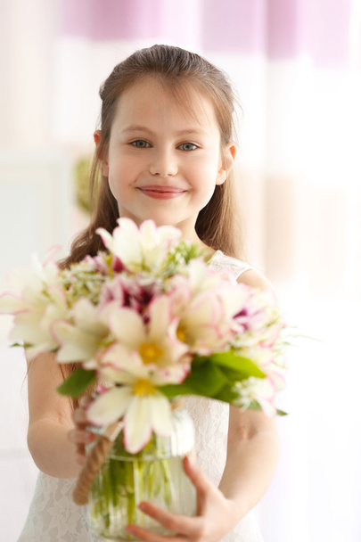 Beautiful small girl with bouquet - Фото, зображення