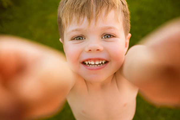 Little boy making selfie on the grass - Photo, Image
