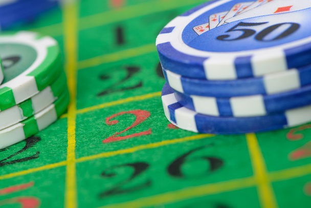 Gaming chips on the green cloth - 写真・画像