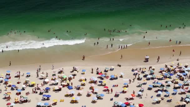 People sunbathing on Copacabana beach - Materiał filmowy, wideo