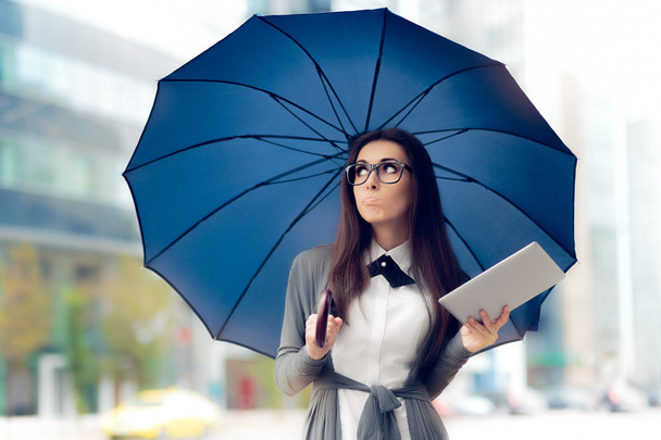 Disappointed  Woman with Glasses, Tablet and Umbrella Out in the City - Photo, image