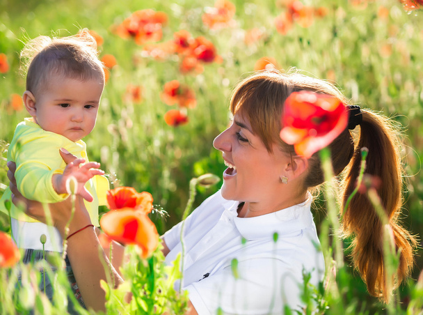 Mother and daughter with red poppies - Фото, изображение