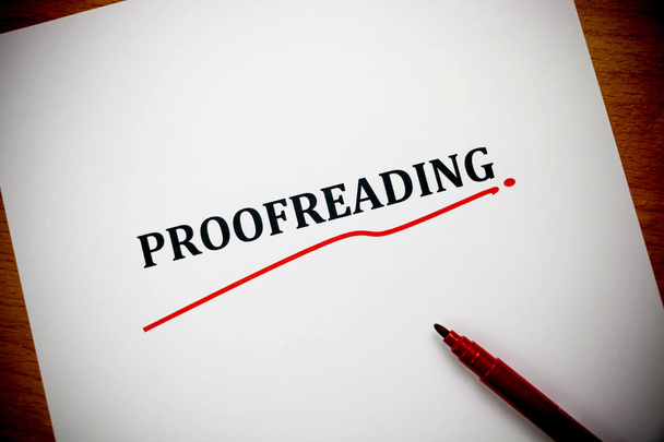 proofreading word on white sheet with red pen - Photo, Image