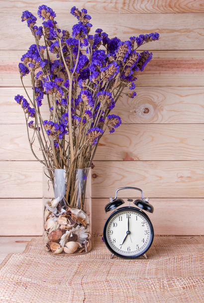 Clock with violet flower on wood background - Foto, Imagem