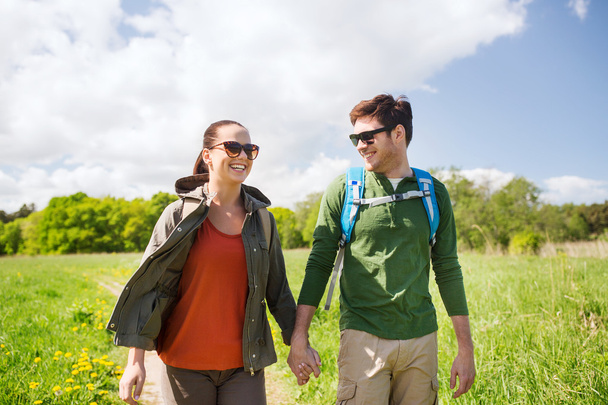 happy couple with backpacks hiking outdoors - Fotó, kép