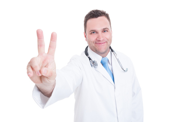 Smiling young doctor showing peace or victory sign - Photo, Image