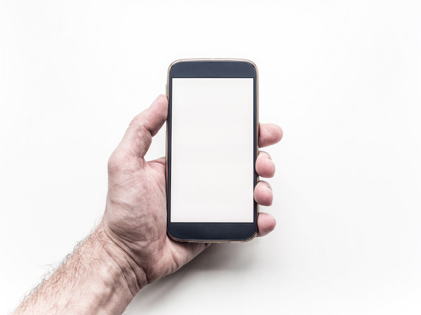 Man's hand holding and using mobile smartphone on white background - Foto, afbeelding