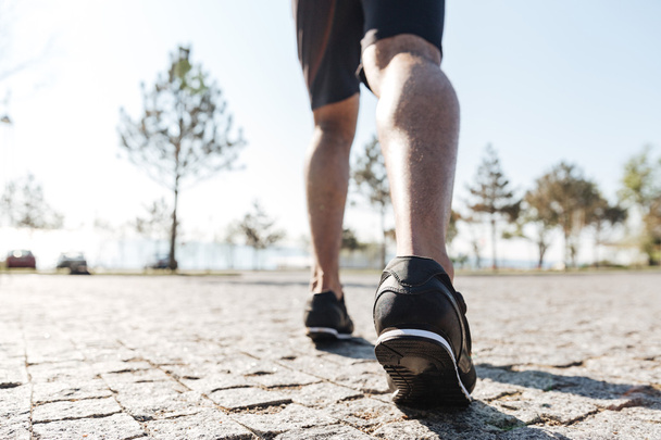 Legs of male sportsman running in the city - Foto, Imagem
