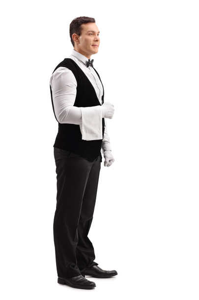Young male waiter holding a towel  - Fotó, kép