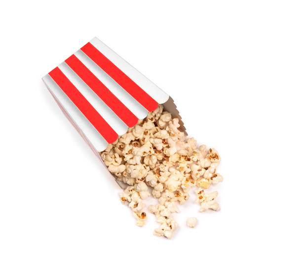 Popcorn in striped bucket on white background - Фото, зображення