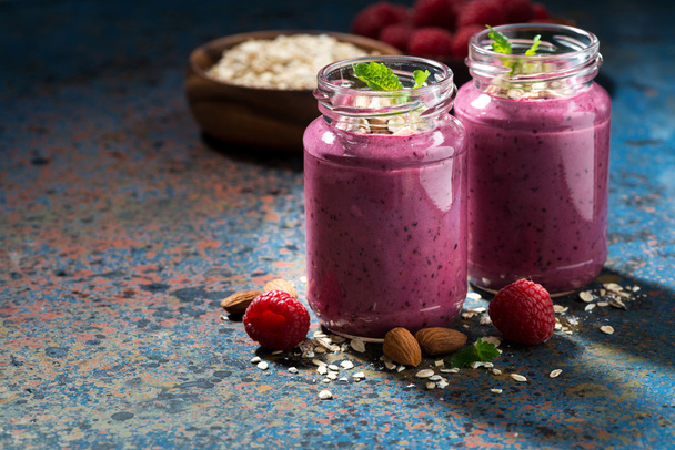 healthy berry smoothies with oatmeal on a dark background - Фото, изображение
