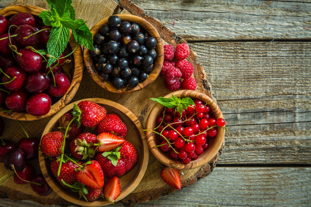 Selection of colorful berries on rustic background - Foto, Bild