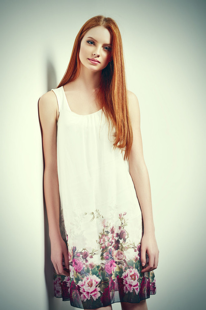 Beautiful female in sleeveless flower print summer dress - Foto, imagen