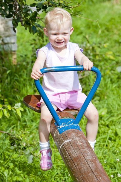 Little girl sitting on swing - Фото, зображення