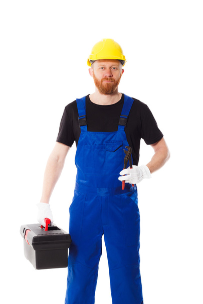 Людина будівельник у синій формений одяг - Фото, зображення