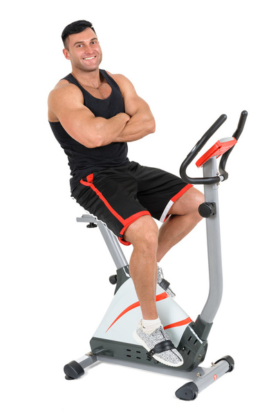 young man doing exercises on elliptical cross trainer - Photo, Image