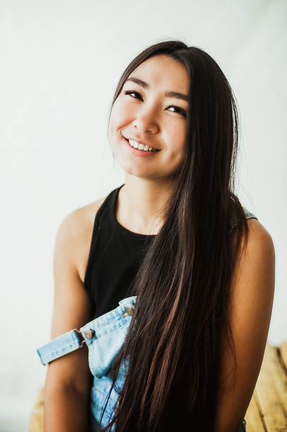 young beautiful asian woman with long hair posing in studio  - Photo, image