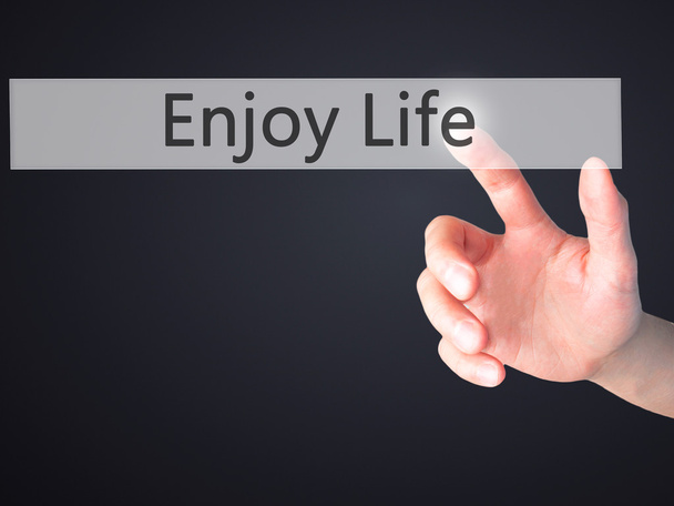 Enjoy Life - Hand pressing a button on blurred background concep - Foto, Imagen