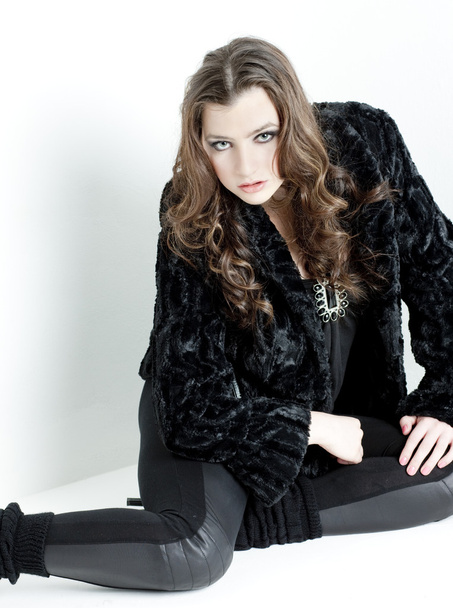 Sitting young woman wearing black clothes - Zdjęcie, obraz