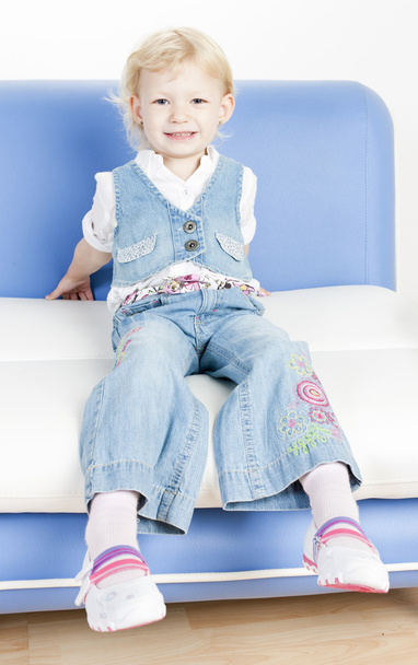 Little girl sitting on sofa - Photo, image