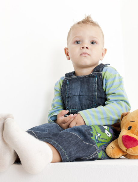 Sitting toddler with a toy - Foto, afbeelding