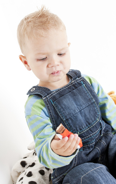 Portrait of little boy eating chocolate - Photo, Image