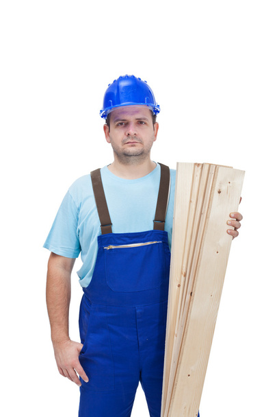 Worker in uniform holding wooden planks - Φωτογραφία, εικόνα