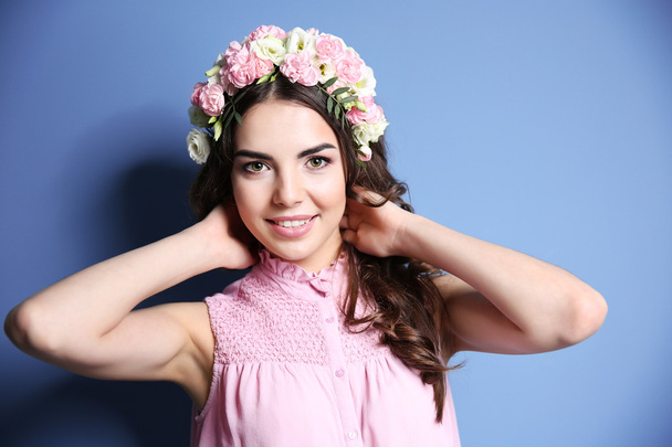 Beautiful woman with flowers on head - Фото, зображення