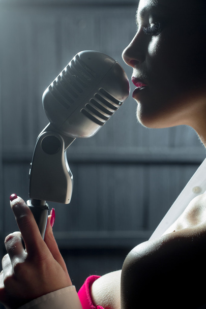 sensual woman with microphone - Фото, изображение