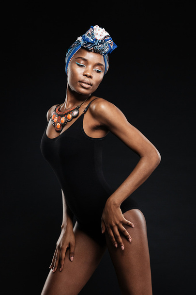 Portrait of slim sexy african woman in bodysuit posing - Foto, afbeelding