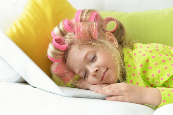 girl in hair curlers sleeping in her bed - Foto, Imagem
