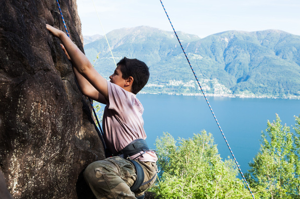 child climbs on rock wall - Fotó, kép