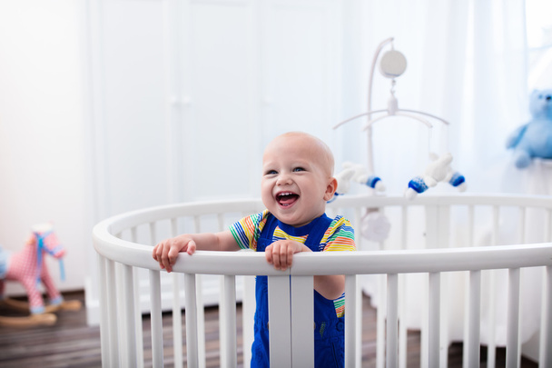 Baby boy standing in bed - Photo, Image