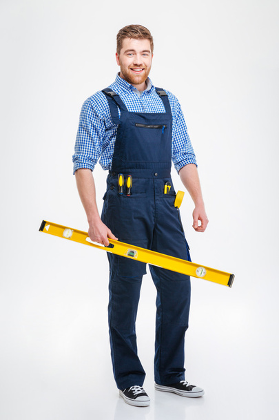 Smiling male builder holding waterpas - Photo, Image