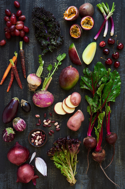 raw fruits and veggies on dark background - Valokuva, kuva