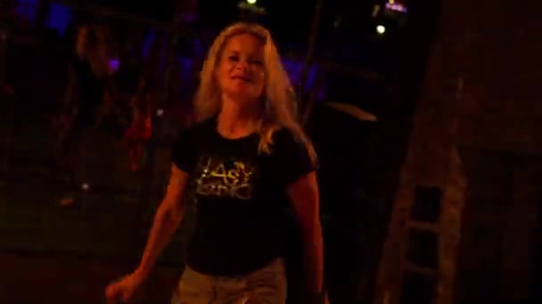 Attractive young woman dancing in a nightclub on a dancefloor - Кадри, відео