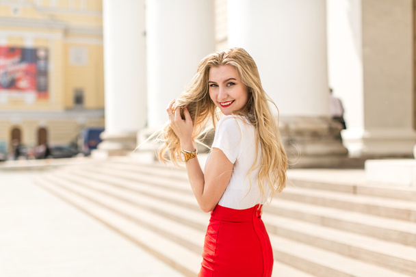 Young beautiful woman with long hair walking in city - Zdjęcie, obraz