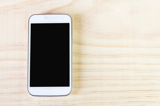 Smart phone on wooden background - Photo, image