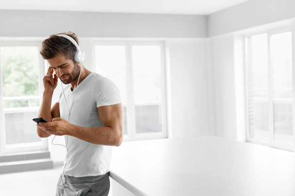 Music Listening. Man In Headphones Using Mobile Phone Indoors - Foto, Imagem