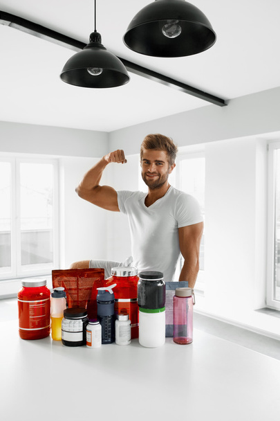 Sport Nutrition. Healthy Man With Bodybuilding Supplements - Valokuva, kuva