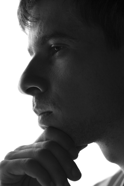 sad man silhouette on a white background - Foto, afbeelding