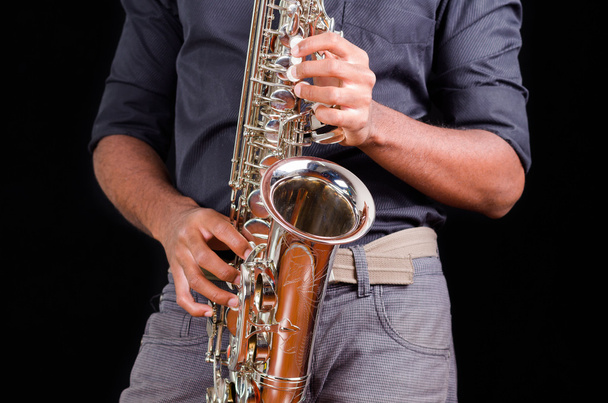 Saxophone view with hands playing it, view of the front - Photo, Image