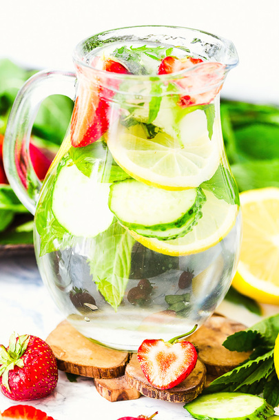 water-detox with lemon, strawberries and mint on light backgroun - Fotó, kép