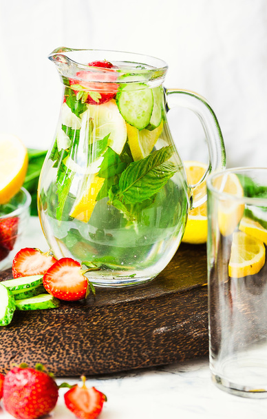Water with strawberries, lemon, ice, mint. Detox. - Photo, Image