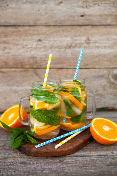 Fresh cocktail with orange, mint and ice, selective focus - Valokuva, kuva